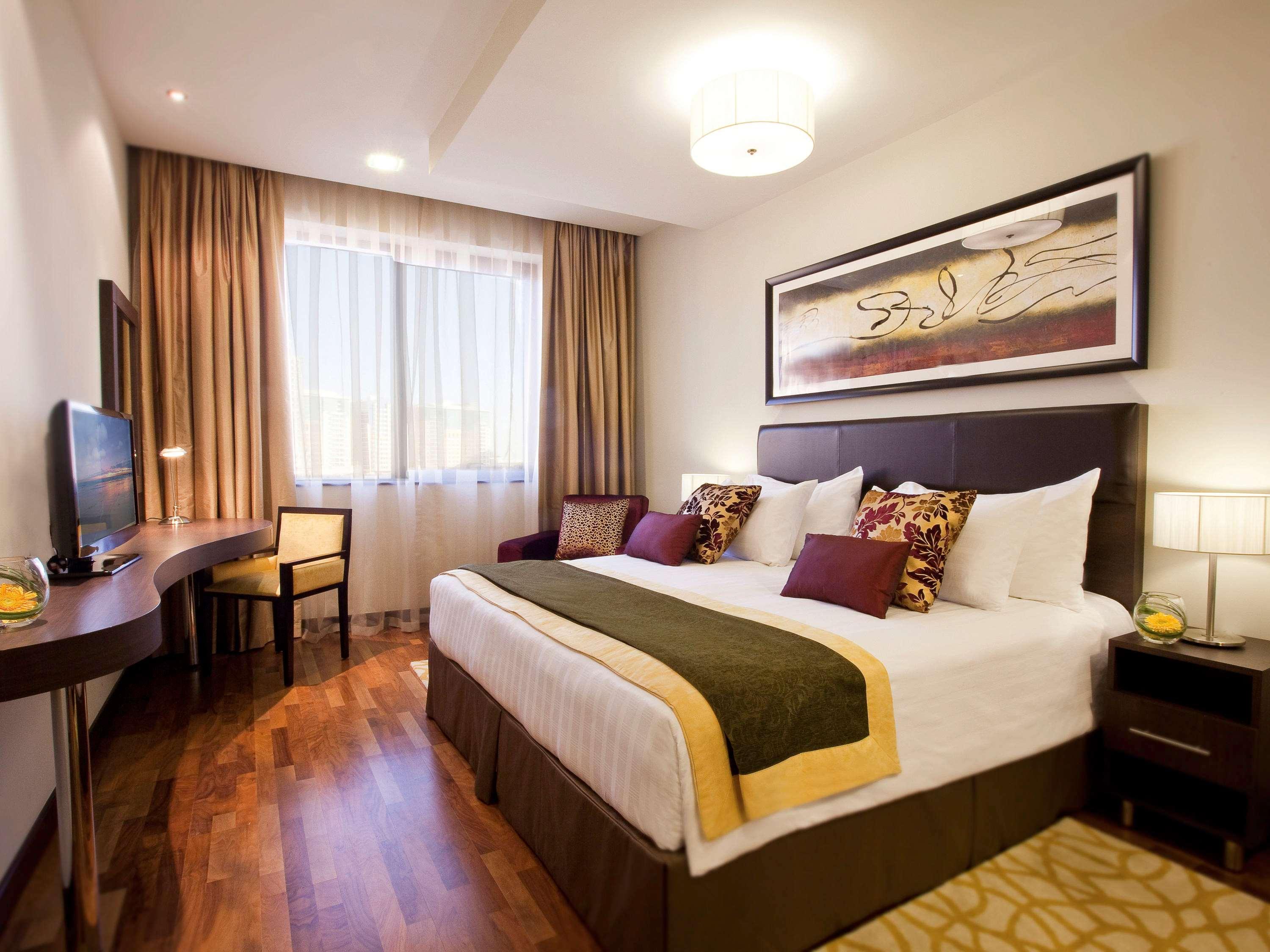 Moevenpick Hotel Apartments Al Mamzar Dubai Luaran gambar A bedroom at the hotel